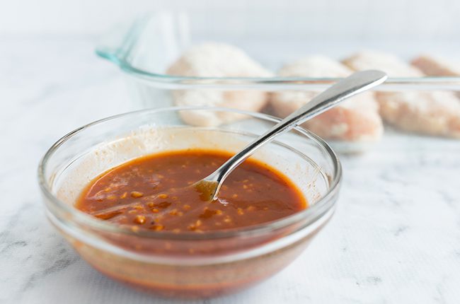 bbq sauce and garlic in a boowl with chicken