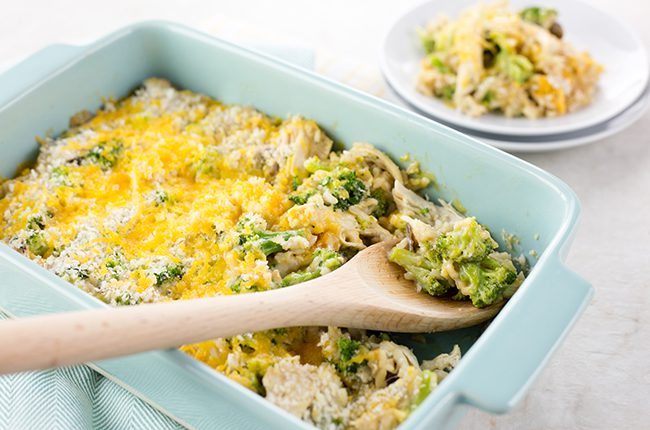 the best chicken and rice recipe cooked in casserole dish and spoon for serving