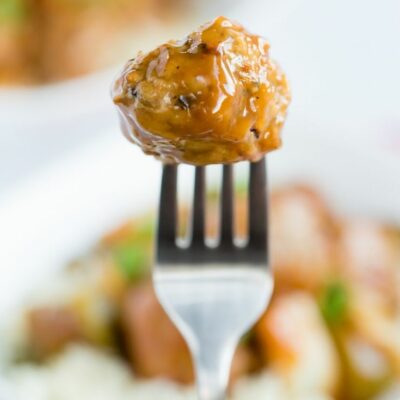 A fork holding a single chicken meatball