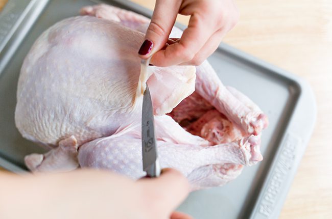stuffing a turkey on a baking sheet