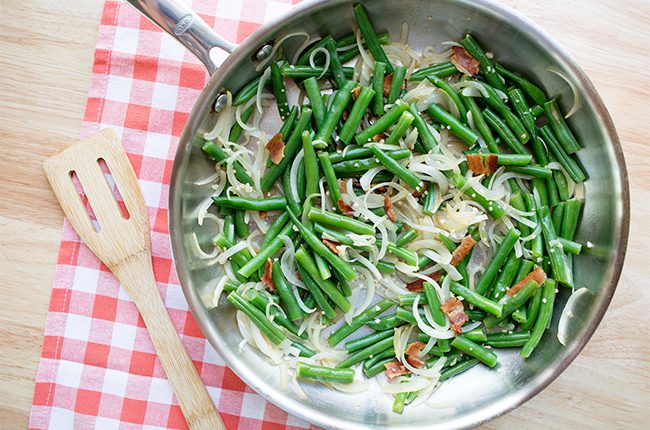 green beans, bacon and cheese in a frying pan