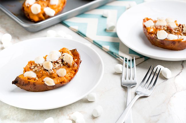 Twice baked sweet potatoes prepared and on white plates with forks beside them