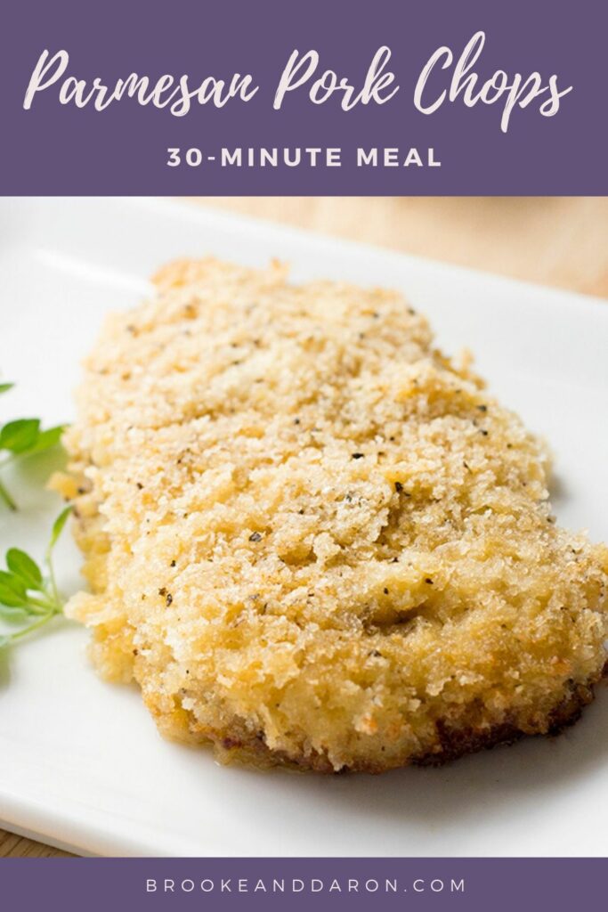 Parmesan pork chop on white plate with parsley