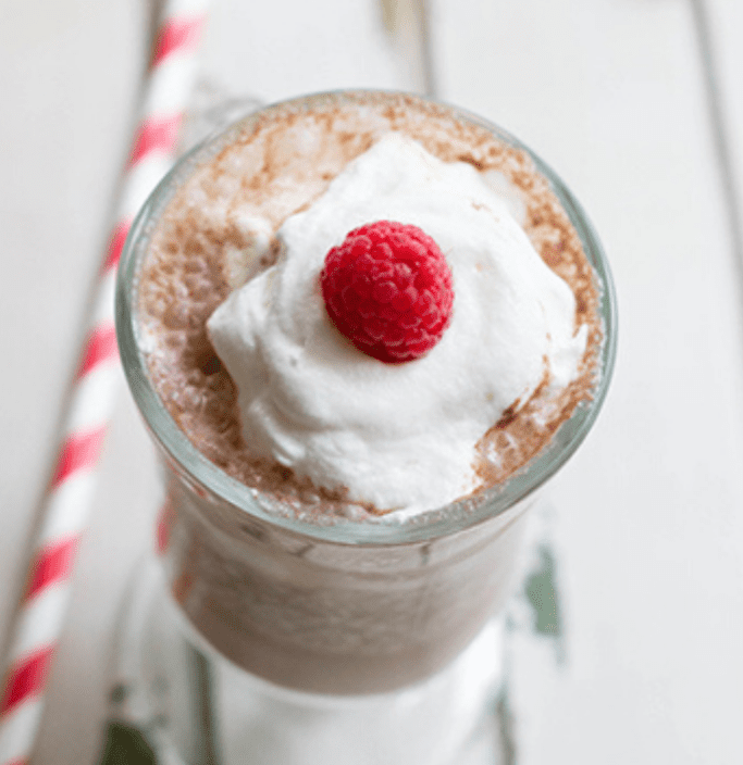 Raspberry mocha smoothie in glass with raspberry on top