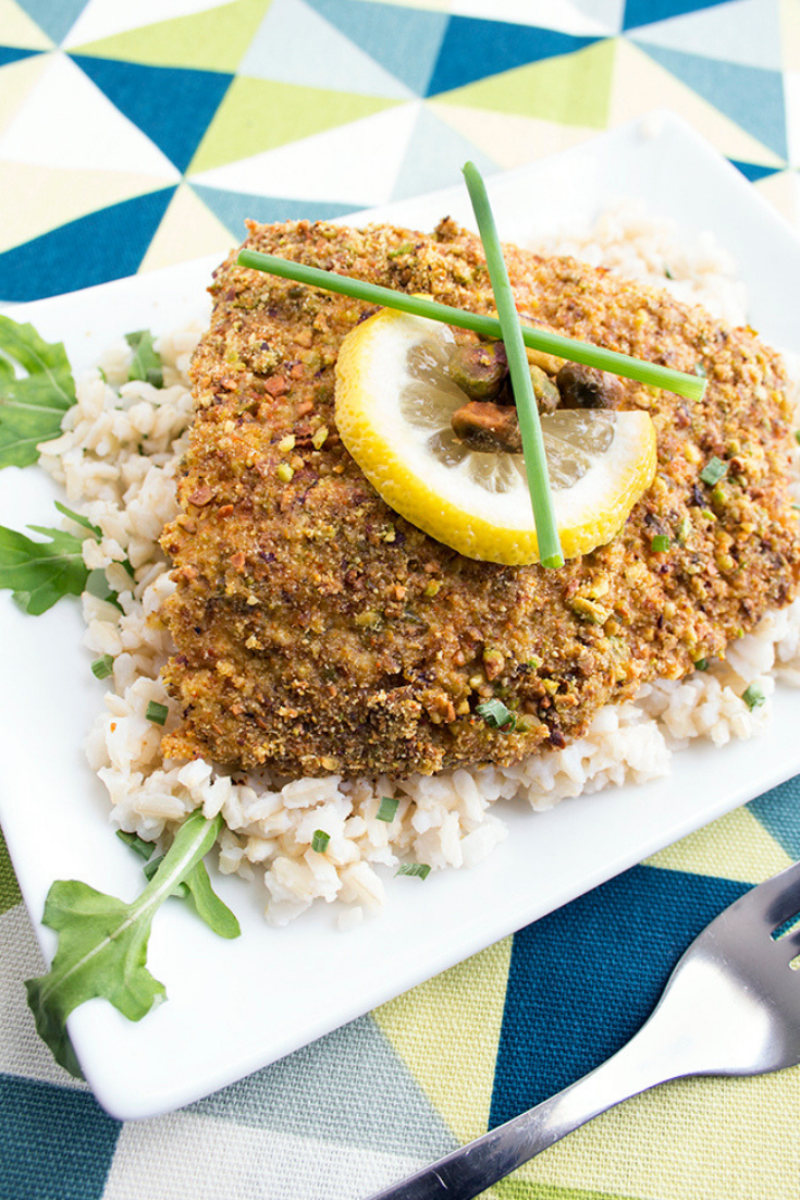 Up close overhead picture of baked halibut sitting on rice