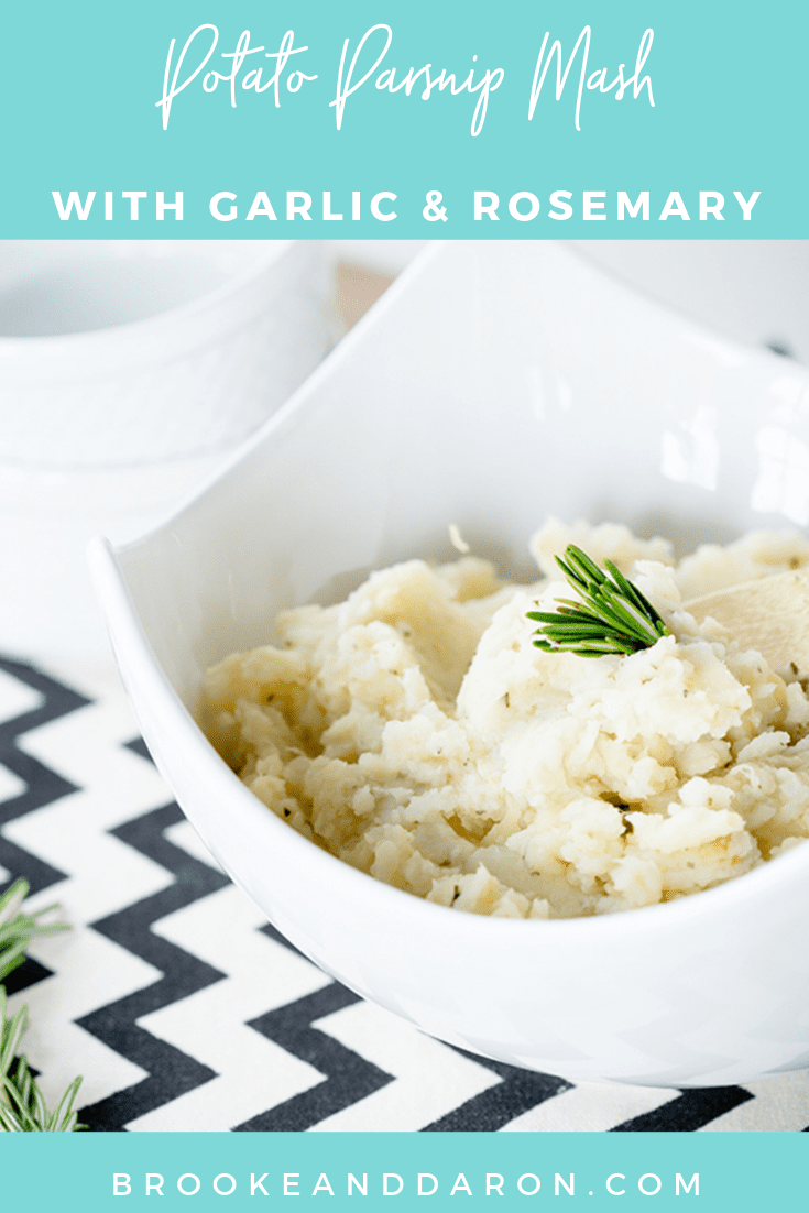 A large white bowl of parsnip mash with a sprig of rosemary on top