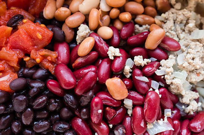 Close up picture of beans and turkey in a stockpot
