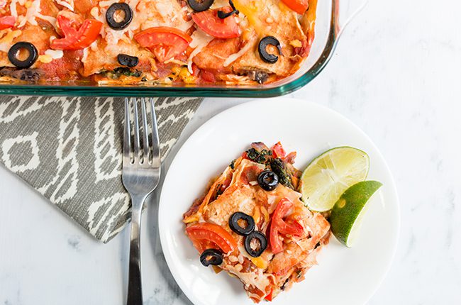Overhead pictuer of a serving of mexican lasagna on white plate