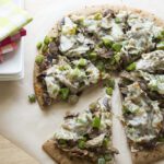 Up close overhead picture of a sliced philly cheesesteak pizza