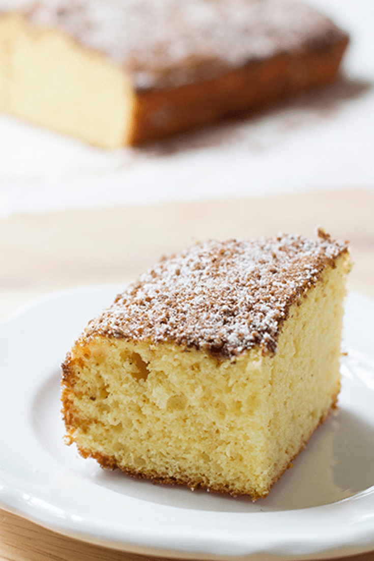 Up close picture of a single slice of coffee cake on a white saucer