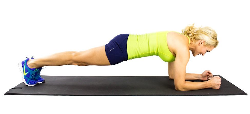 girl doing a forearm plank in beginner ab workout plan