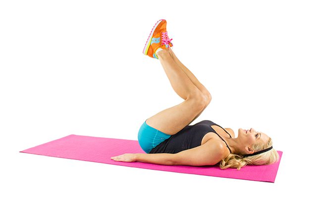 girl doing a reverse crunch in beginner ab workout plan