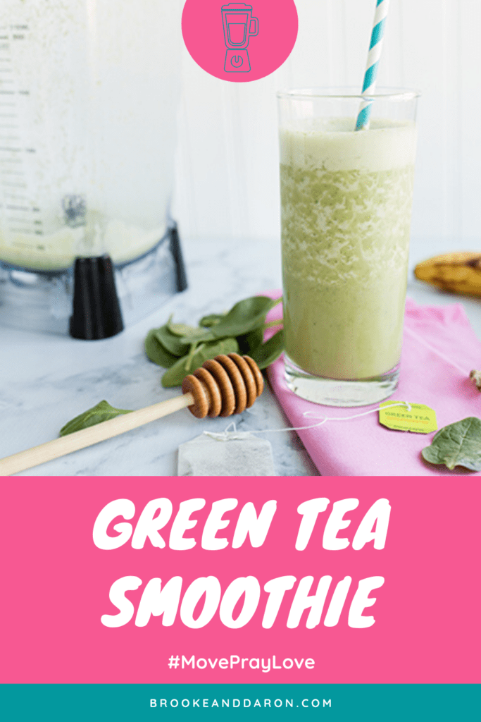 Green smoothie next to blender on pink napkin