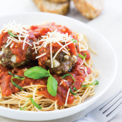 overhead shot of spaghetti and meatballs plated on a white plate
